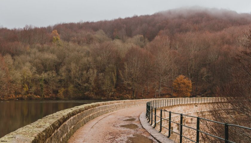 footbridge with stone facade over water